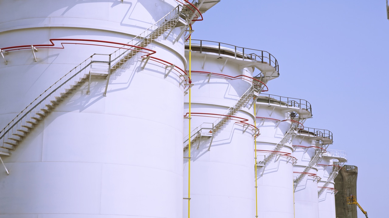 Petroleum storage tanks with external access stairways and perimeter piping