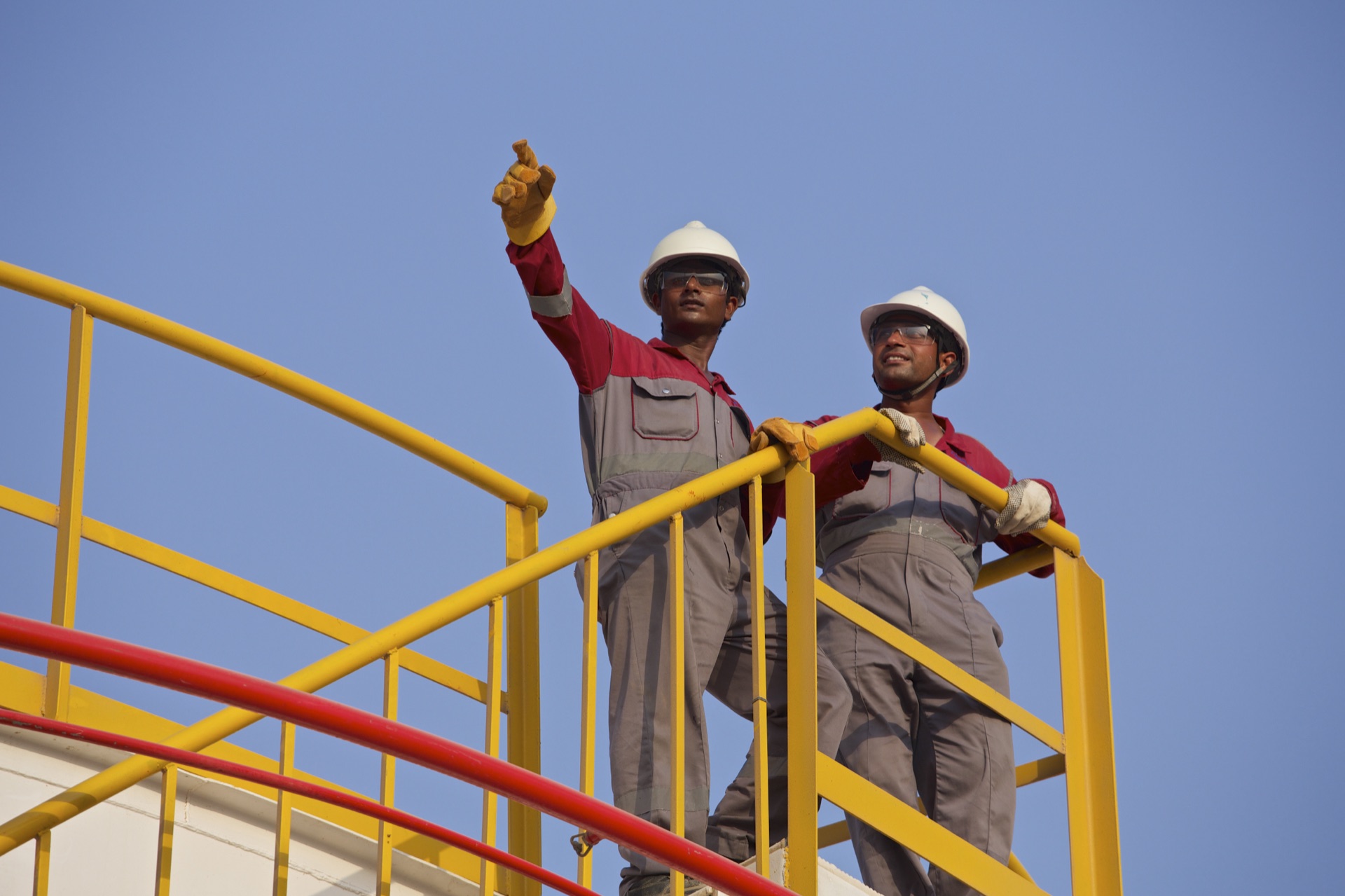 Chemie-Tech site team in PPE reviewing work from an access platform